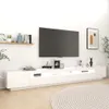 A white TV stand with a large television mounted above it, in a room with a white wall and wooden floor. Náhľad obrázku produktu