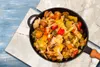 A close-up overhead view of a pan filled with a colorful vegetable stir-fry. Anteprima dell’immagine prodotto