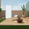 An outdoor patio setting with furniture and plants, featuring a white banner stand. Podgląd zdjęcia produktu