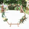 A hexagonal wooden arch decorated with balloons and flowers, set up outdoors for an event. Náhled obrázku produktu