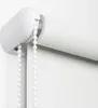 A close-up view of a white roller blind mechanism and fabric. Produktbild-Vorschau