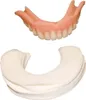 A set of dentures and a package of denture liners. Produktbild-Vorschau