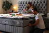 A family is reading a book on a bed. Produktbild-Vorschau