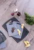 A collection of cutting boards and ingredients on a wooden surface. Produktbild-Vorschau