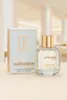 A perfume bottle and its box are displayed on a neutral surface with a blurred background. Produktbild-Vorschau