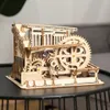 A wooden marble run model is displayed on a dark table. Podgląd zdjęcia produktu