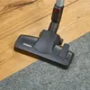 Vacuum cleaner head on a wooden floor and carpet. Podgląd zdjęcia produktu