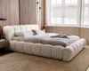 A bedroom scene featuring a large, plush bed. Náhled obrázku produktu