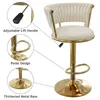 A beige velvet bar stool with gold accents, shown with callouts highlighting its adjustable lift handle, pedal design, and thickened metal base. Voir les images du produit