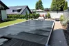 A covered swimming pool in a backyard setting. Produktbild-Vorschau