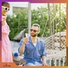 A man and a woman are enjoying drinks outdoors, with a hammock chair visible. Produktbild-Vorschau