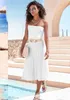 A woman is walking by a pool in a resort-like setting. Produktbild-Vorschau