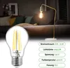 A close-up of an LED light bulb with a lamp and sofa in the background, along with product specifications. Produktbild-Vorschau