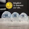 Three silicone breast milk collectors of varying sizes are displayed on a reflective surface, with a dark background. A "Mom's Choice Awards" badge and promotional text are overlaid on the image. Produktbild-Vorschau