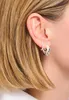 Close-up of a woman's ear wearing earrings. Podgląd zdjęcia produktu