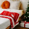 A cozy bedroom scene with a Christmas tree and a wrapped gift. Podgląd zdjęcia produktu