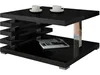 A modern black coffee table with a magazine on the lower shelf and two cups on the top shelf. Náhled obrázku produktu