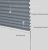 Close-up view of a dark gray pleated blind with labels pointing out its features. Produktbild-Vorschau