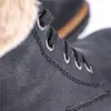A close-up shot of the lacing area of a black boot. Anteprima dell’immagine prodotto