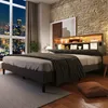 A bedroom scene at night with a city view from the window. Náhled obrázku produktu