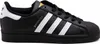 A studio shot of a single black Adidas Superstar sneaker with white stripes and gold accents. Podgląd zdjęcia produktu