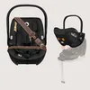 A split image showing a black baby car seat on the left and the same car seat being attached to a base on the right. Produktbild-Vorschau