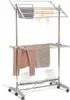 A multi-tiered electric clothes drying rack with clothes hanging on it, against a white background. Náhled obrázku produktu