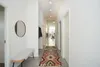 A modern hallway with a bench, mirror, and a runner rug. Produktbild-Vorschau