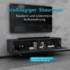 A wall-mounted TV cabinet with its doors open, displaying some items inside, with a TV mounted above it on a concrete wall. Produktbild-Vorschau