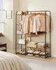 A bedroom scene featuring a clothing rack filled with garments and shoes, and a portion of a bed. Náhled obrázku produktu