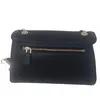 A black Guess handbag is shown from the back, with a zipper pocket visible. Produktbild-Vorschau
