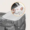 A baby on a changing pad attached to a baby crib. Podgląd zdjęcia produktu