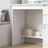 A close-up view of a white desk with shelves, showing storage boxes on one of the shelves. Náhľad obrázku produktu