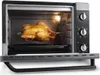 A toaster oven with a chicken roasting on a rotisserie inside. Produktbild-Vorschau