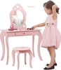 A young girl is playing with a pink toy vanity set. Náhľad obrázku produktu