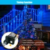 A decorated Christmas tree and porch railing illuminated by blue string lights, with Halloween-themed decorations like pumpkins and jack-o'-lanterns in the foreground. Produktbild-Vorschau