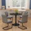 A dining set with a round table and four chairs in a kitchen setting. Anteprima dell’immagine prodotto