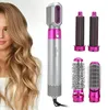 Silberne und pinkfarbene 5-in-1 Haarstylingbürste mit mehreren Aufsätzen, neben einer Frau mit langen welligen blonden Haaren Voir les images du produit