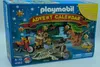 The image shows the front of a Playmobil Advent Calendar box with a dinosaur expedition theme. Produktbild-Vorschau