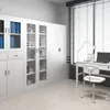 A clean, well-lit room with white cabinets, a desk, and a chair next to a window with blinds. Produktbild-Vorschau