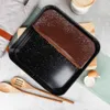A chocolate cake is presented in a baking pan, surrounded by baking accessories. Podgląd zdjęcia produktu