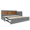 A grey upholstered daybed with a pull-out trundle bed extended, featuring a wooden shelf headboard. Náhled obrázku produktu