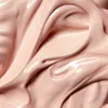 A close-up, abstract view of a creamy, shimmering cosmetic product. Podgląd zdjęcia produktu