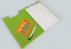 An open green clipboard with a sheet of white paper and a pen. Produktbild-Vorschau