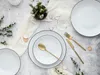 A flat lay of a dinnerware set on a textured surface. Náhľad obrázku produktu