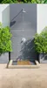 An outdoor shower area with a bamboo mat in front of the shower. Produktbild-Vorschau