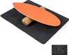 A balance board with a cork roller on a dark gray mat, presented on a white background. Produktbild-Vorschau