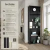 A partial view of a black bookshelf with text and icons describing its features, next to a living room interior. Náhled obrázku produktu