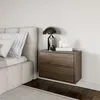 A bedroom scene with a bed and a nightstand. Náhľad obrázku produktu