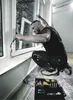 A man is installing or repairing a window, with a toolbox of tools nearby. Produktbild-Vorschau